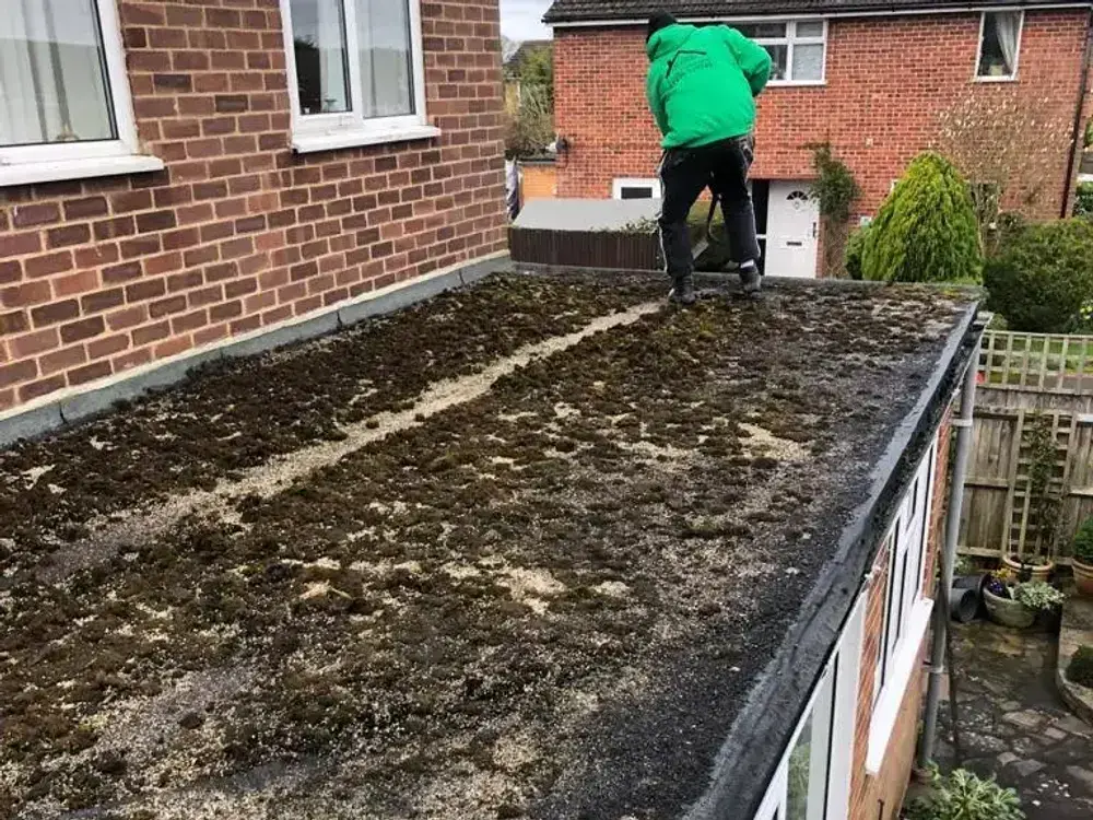 Flat extension roof covered in moss and standing water before A-List Roofing replaced it